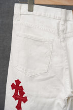 White pants with red cross appliques on the front pockets and hip