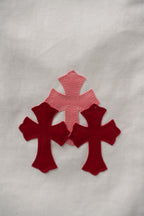 White pants close-up with red cross appliques on the fabric