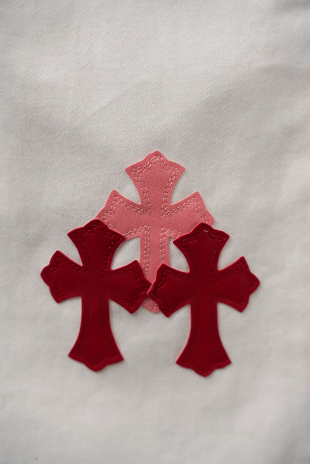 White pants close-up with red cross appliques on the fabric
