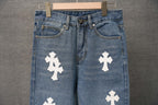 Blue denim pants with belt loops and button fly, white cross patch on front.