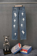 Blue denim pants with repeating white cross patches, button fly, straight leg.