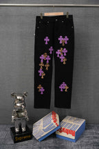 Black pants with purple and gold cross graphic patches, straight leg, button closure.