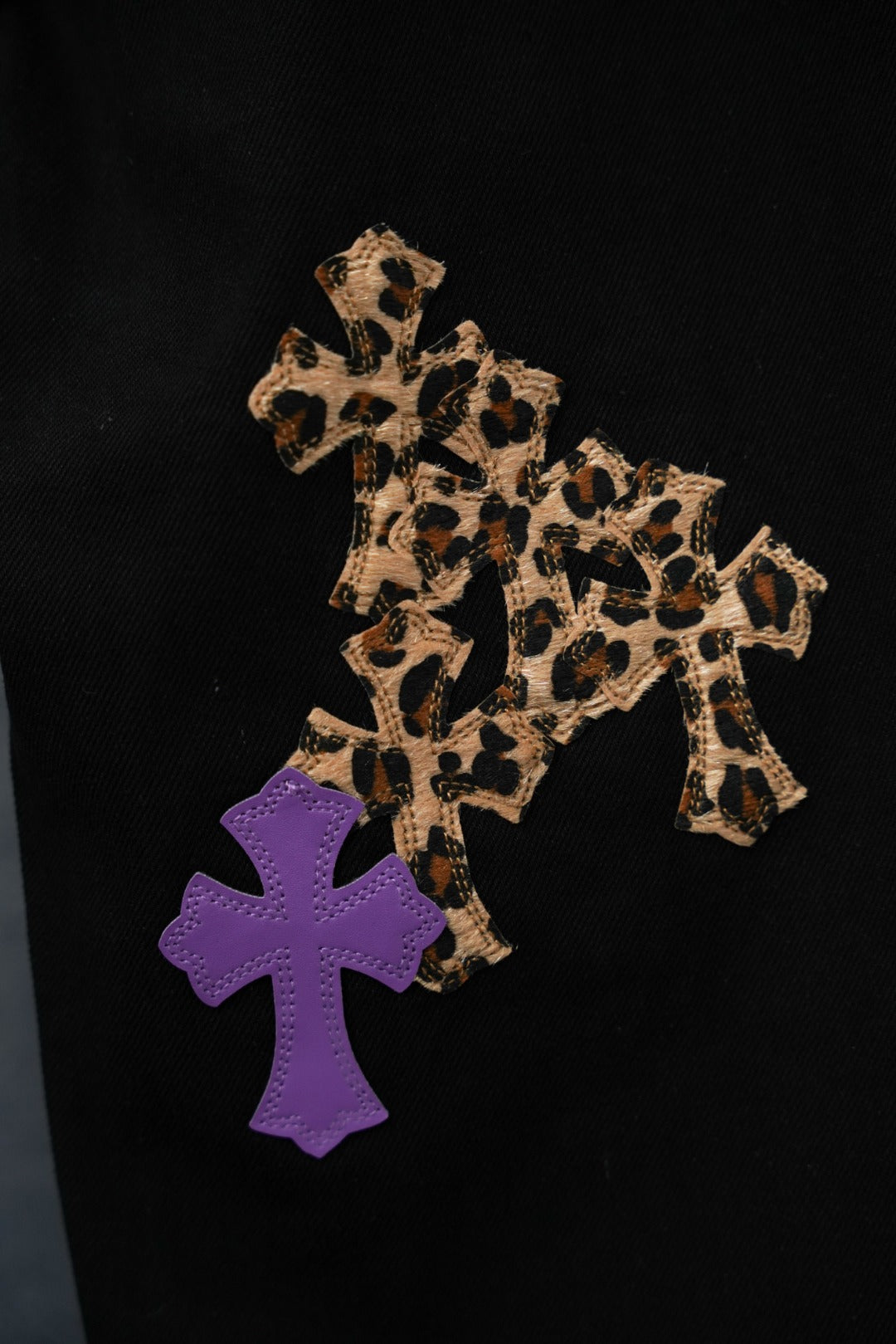 Chrome pants with leopard-print and purple cross applique patches