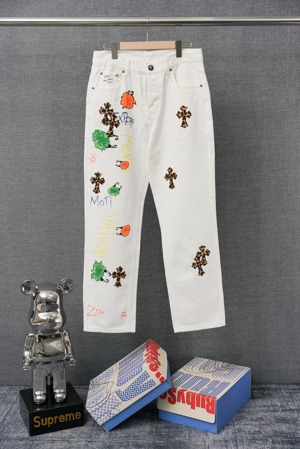 Chrome pants in white with colorful embroidered graphic patches on the legs