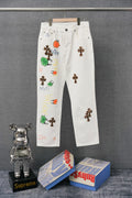 Chrome pants in white with colorful embroidered graphic patches on the legs