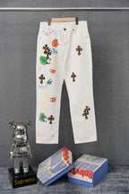 Chrome pants in white with colorful embroidered graphic patches on the legs