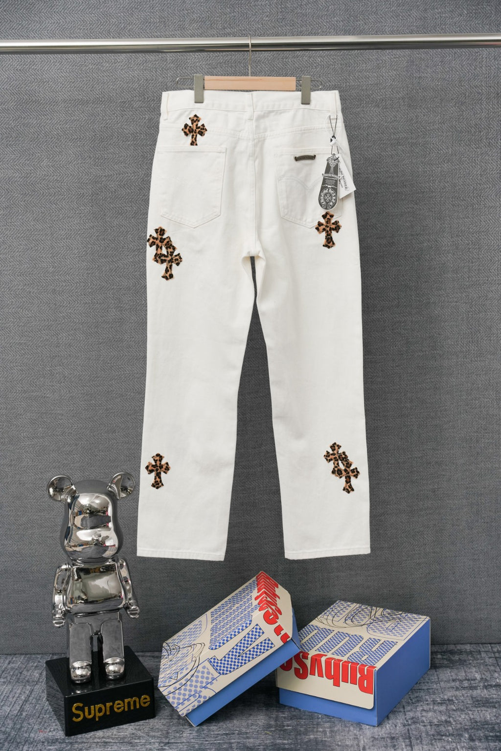 Chrome pants in white with colorful embroidered cross graphic patches and button closure