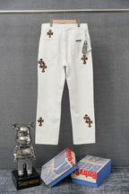 Chrome pants in white with colorful embroidered cross graphic patches and button closure