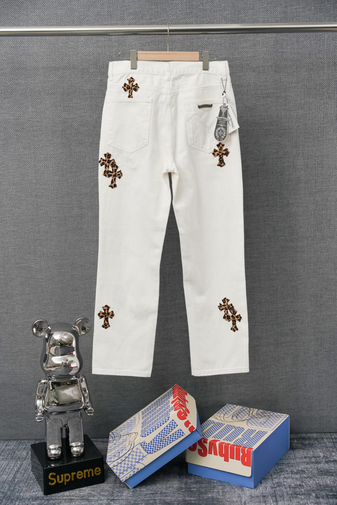 Chrome pants in white with colorful embroidered cross graphic patches and button closure