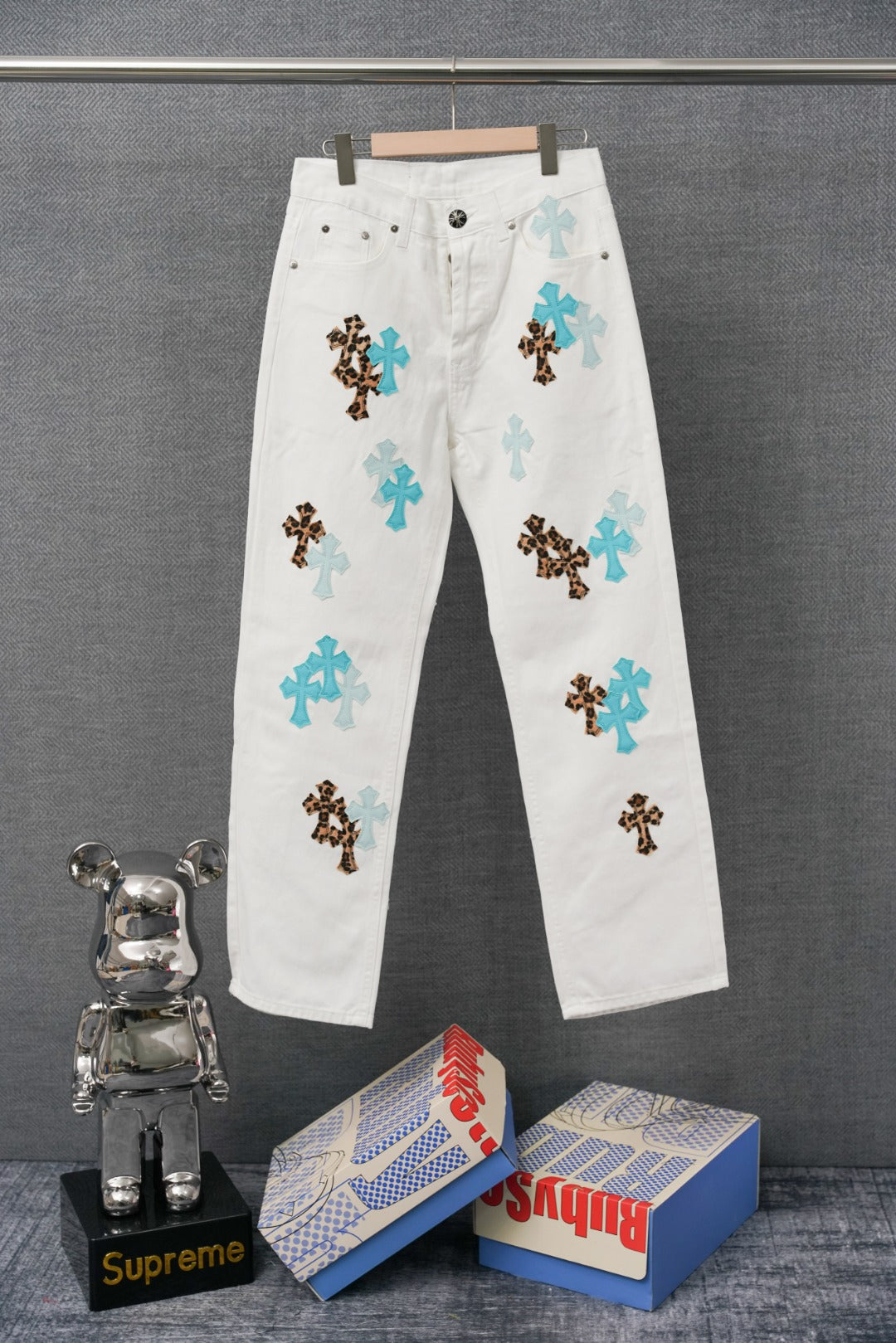 White pants with blue and leopard cross patches