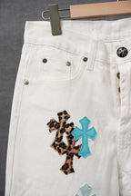 White pants with cross appliques on the front leg
