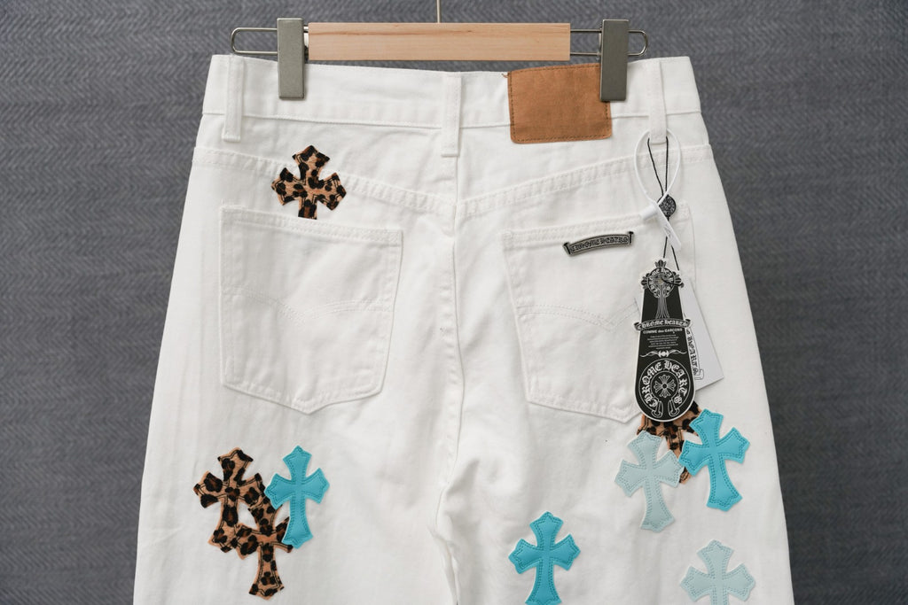 White pants with leopard and teal cross patches, front pockets and size tag