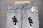 Light blue denim pants with multiple cross patches and button waistband