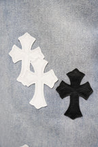 Denim pants with large white and black cross appliqué patches