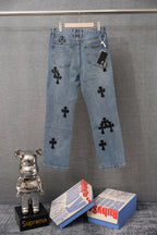 Light blue wide-leg denim pants with black cross patches and graphic patches on legs.
