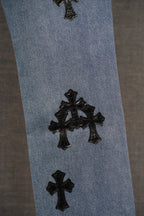 Blue pants with black cross appliques