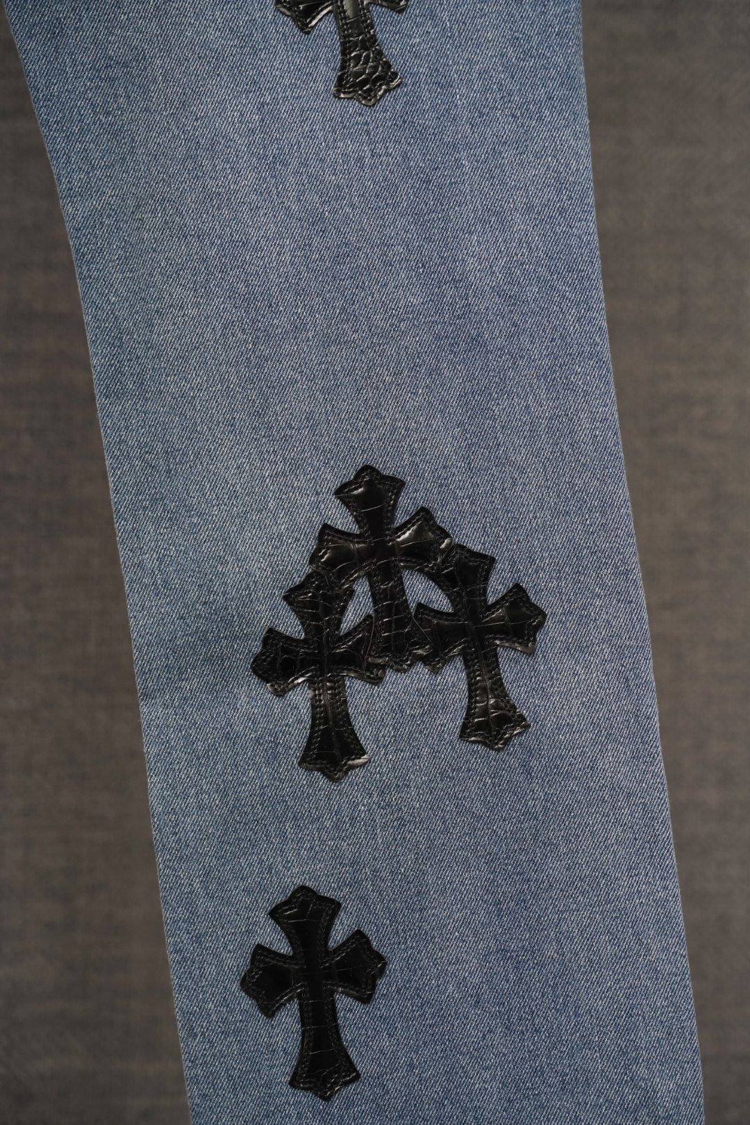 Blue pants with black cross appliques