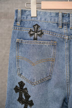 Light blue denim pants with back patch cross on upper pocket area.