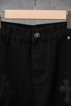 Black pants with waistband button and stitched cross appliques