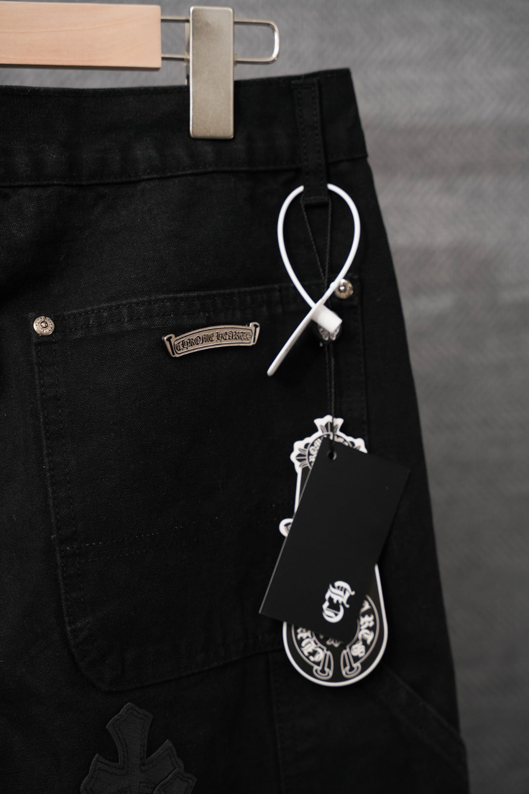 Black pants with D-ring detail and cross applique