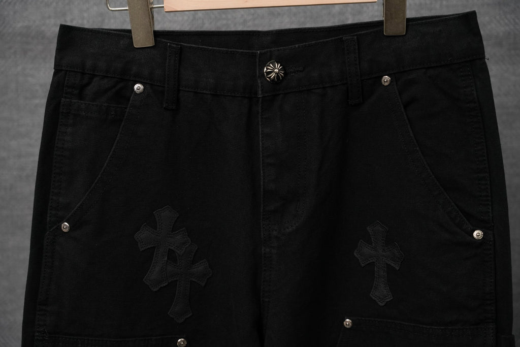 Black pants with waistband button, cross appliques, and belt loops