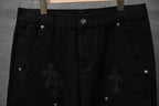 Black pants with waistband button, cross appliques, and belt loops