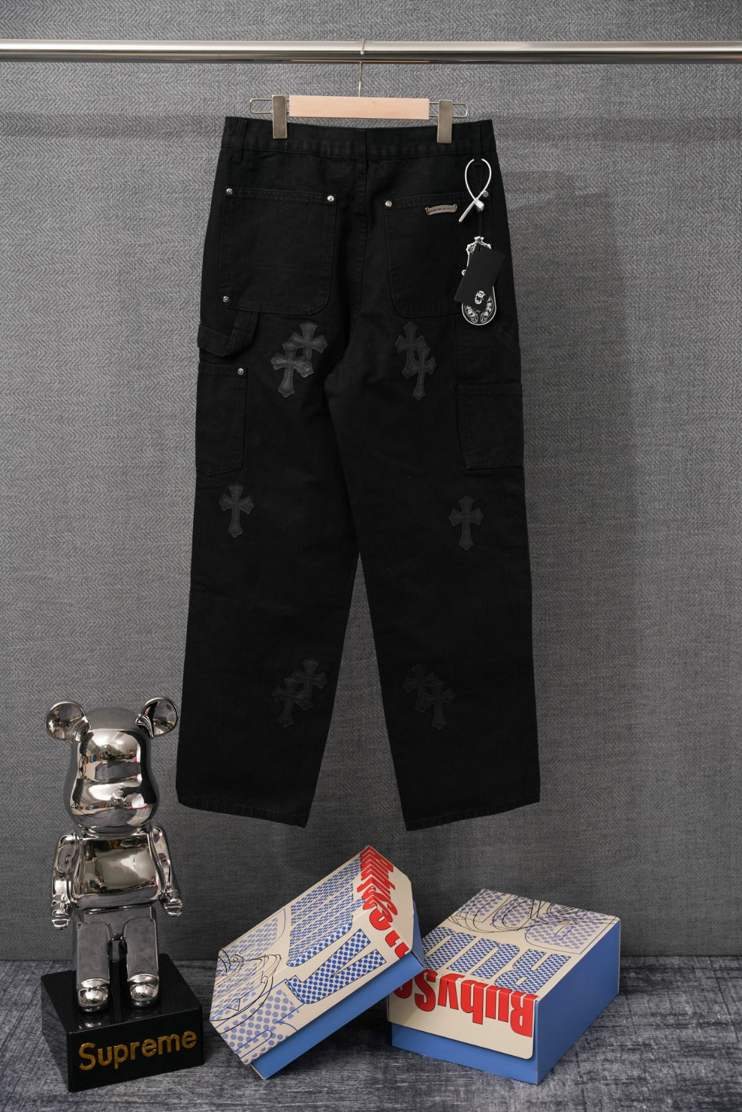 Black pants with cross pattern, drawcord waist, and side pockets