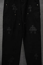 Black pants with cross patches and metal snap button pockets