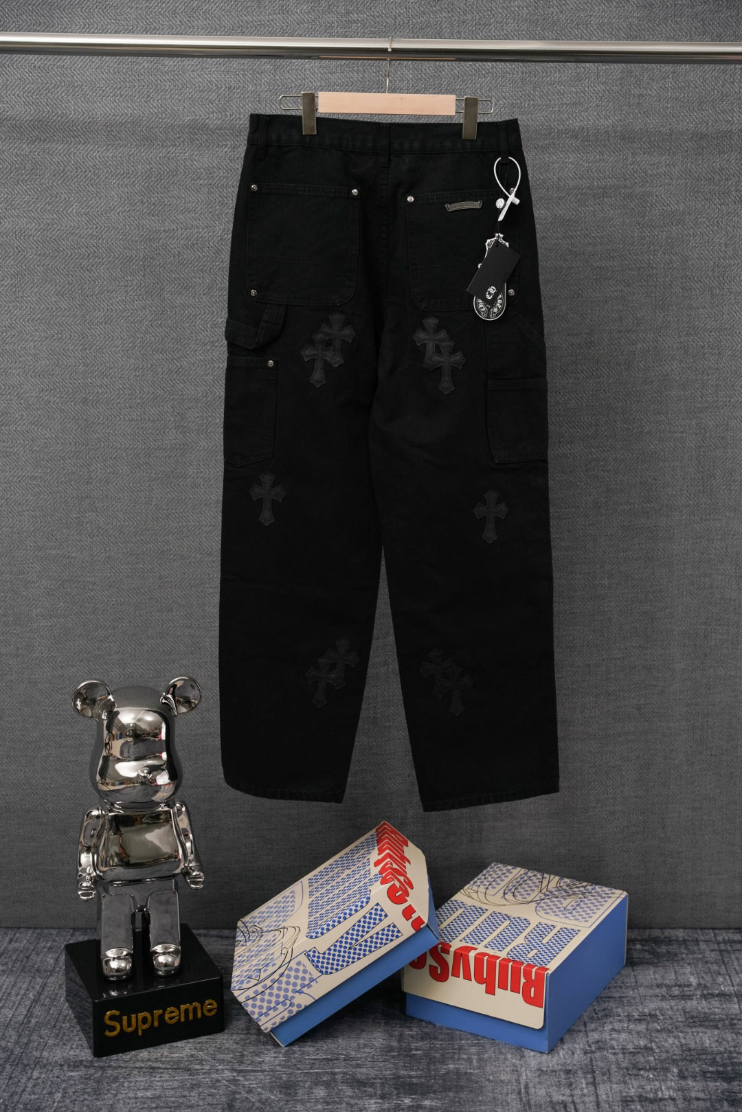 Black cargo pants with embroidered cross motifs and front snap pockets