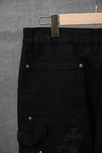 Black cargo pants front pocket with snap button and cross applique detail