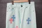 Light blue denim pants with front pockets and visible cross patches at the hip.