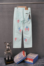 Light blue denim pants with front and side colorful cross applique patches