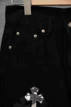 Black pants front pocket with white cross appliqué detail