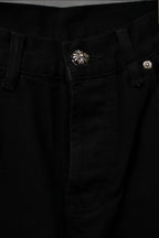 Black pants waistband with button closure and decorative silver shell emblem