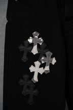Black pants with cross appliqué patches and white lettering detail