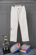 White pants with button fly and small stud detailing at sides