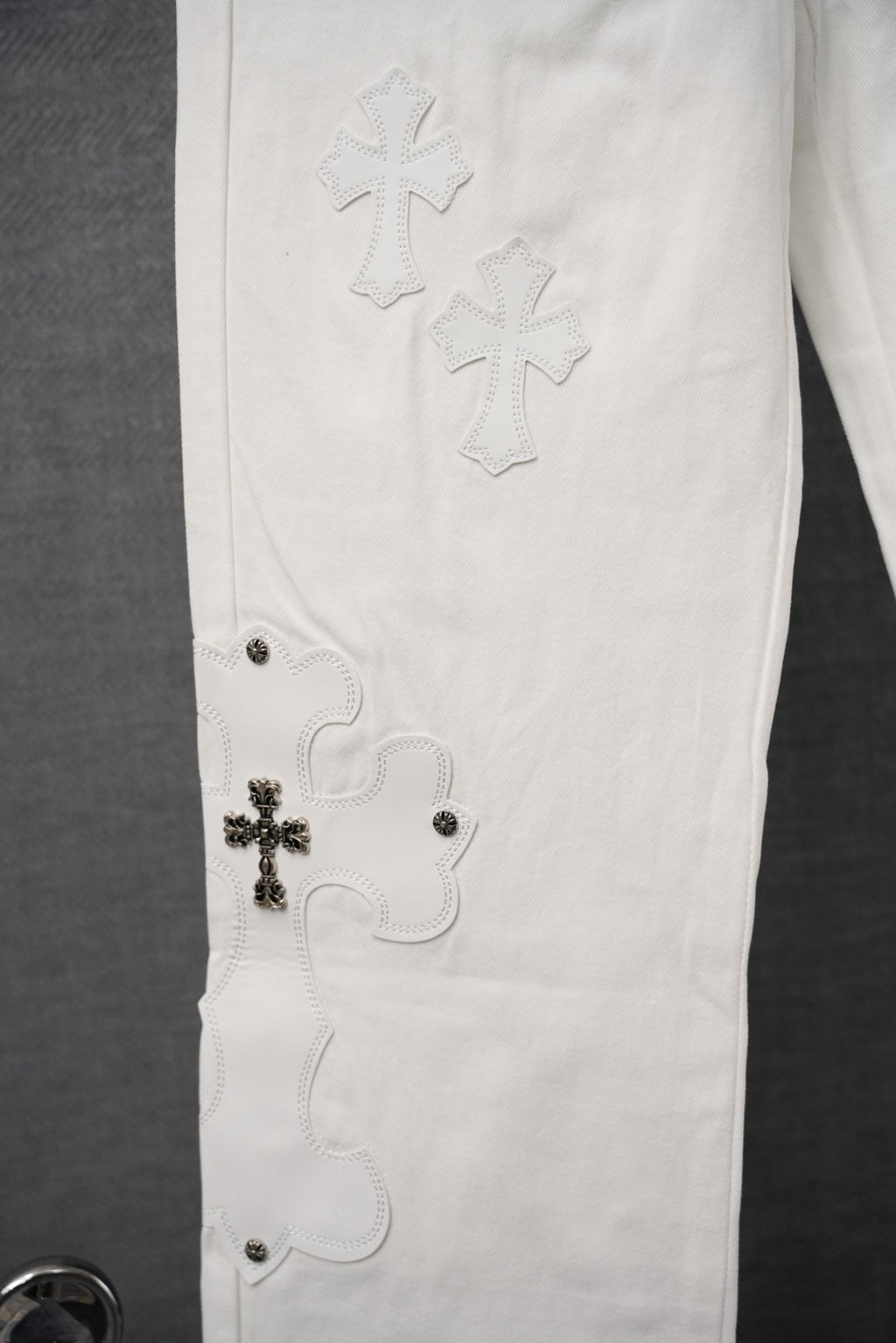 Chrome white pants with cross embroidery on the thigh and small rivet details