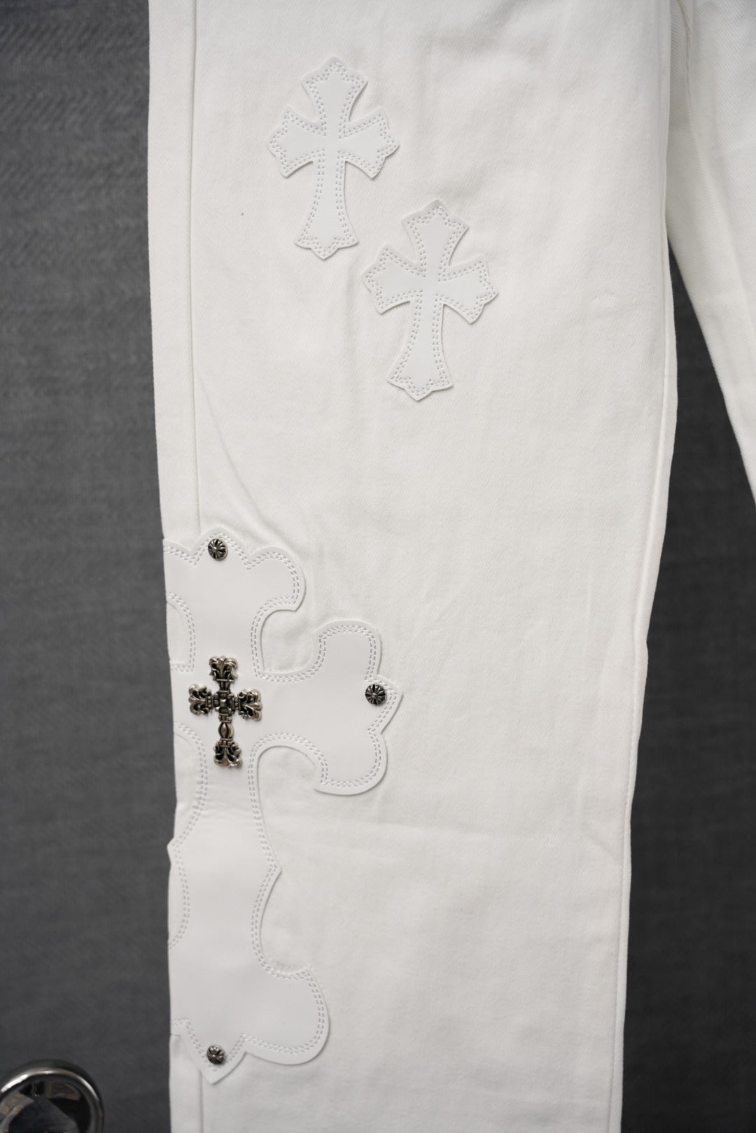 Chrome white pants with cross embroidery on the thigh and small rivet details