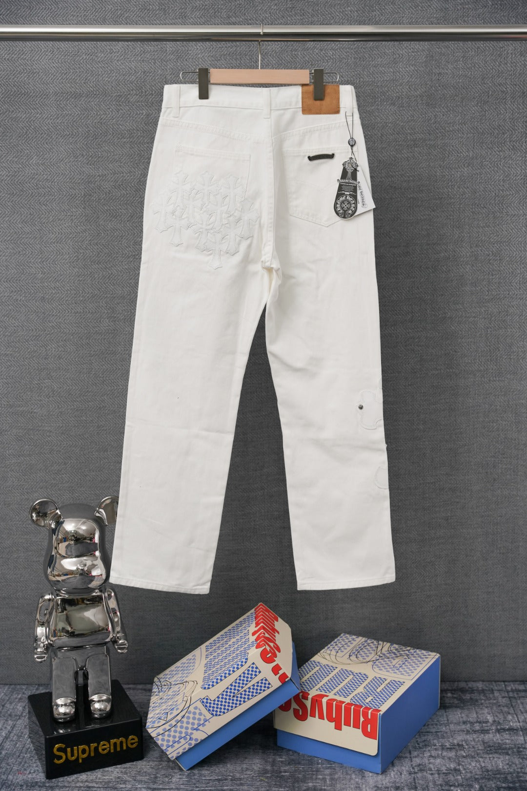 White pants with front button closure and small side hardware detail
