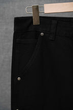 Black cargo pants close-up of waistband, belt loops, and front button