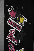 Black pants embroidered patch detail with cartoon graphics
