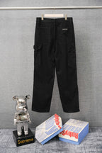 Black cargo pants on hanger with front pockets and straight legs