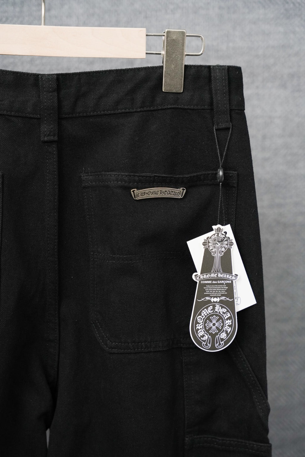 Black pants with front patch pocket and hanging price tag