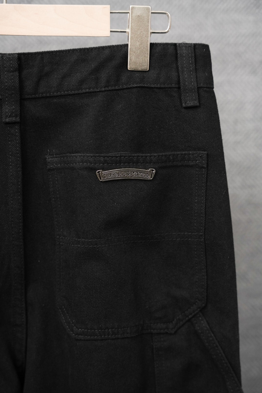 Black pants with front patch pocket and small metal logo label