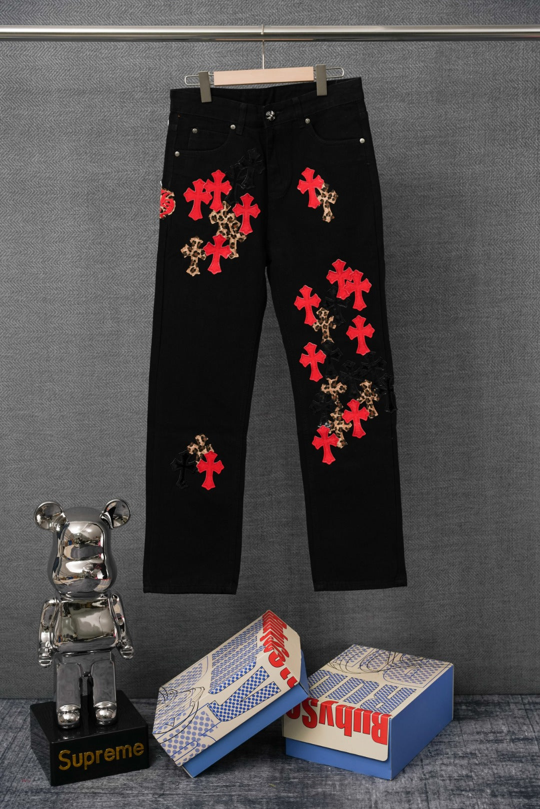 Black pants with red and leopard cross embroidery, front view.