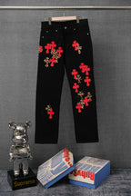 Black Chrome pants with red cross patches and leopard-print details