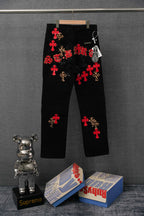 Black Chrome pants with red cross and leopard-print appliques, front view