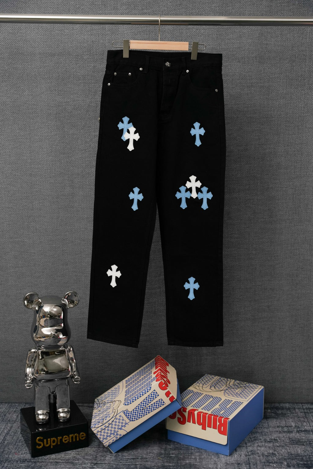 Chrome pants, black with light blue cross patches, front view