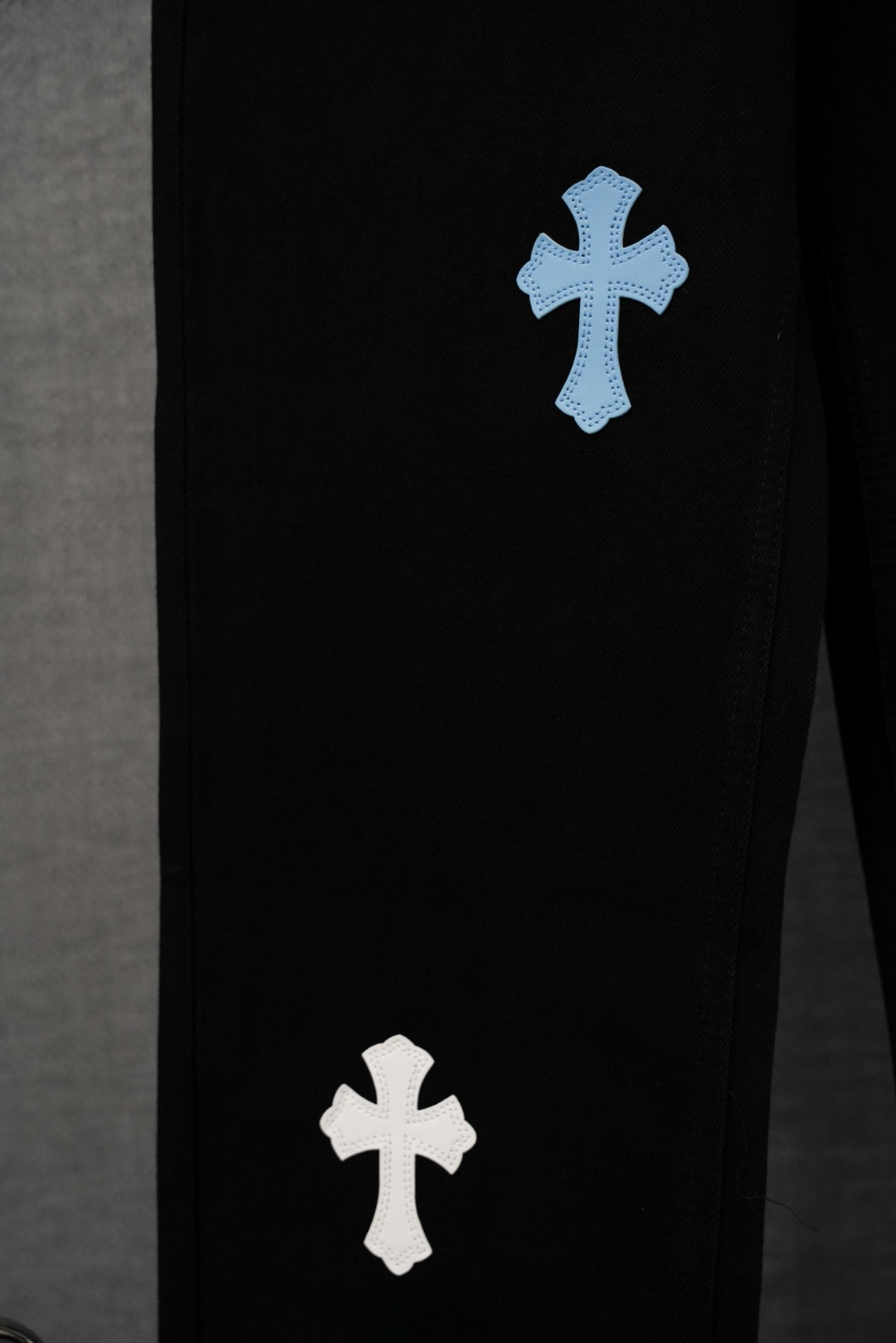 Chrome pants, black with light blue and white cross graphics on leg