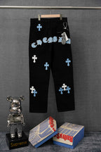 Chrome pants, black with scattered light blue cross patches, front view